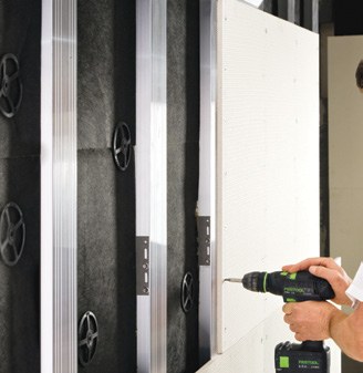 Installer fixing a StoVentec R carrier board to the aluminium sub-construction