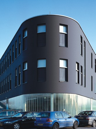 Dark rendered StoVentec R facade curving around a building corner